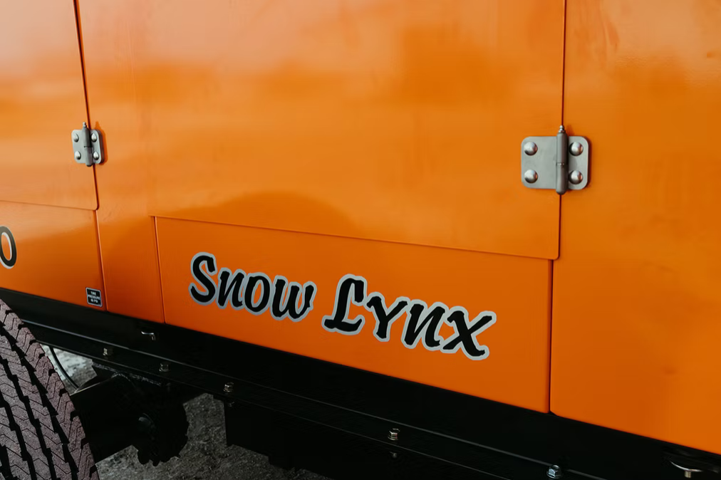 Snow Lynx RS-300 rear view showing engine compartment and dual axle