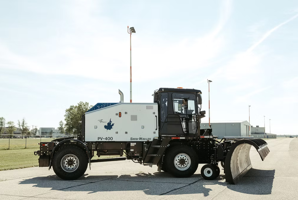 Snow Mauler PV-400 side view with tow broom on airfield