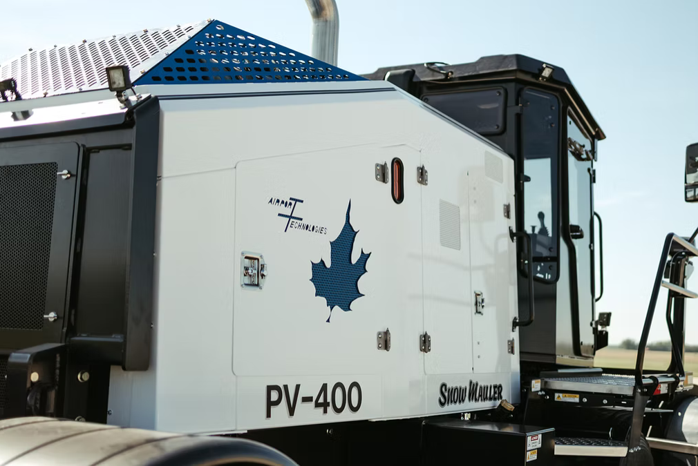 Snow Mauler PV-400 side profile with plow on runway approach lights