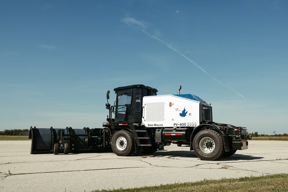 Snow Mauler PV-400 side profile with tow broom on runway